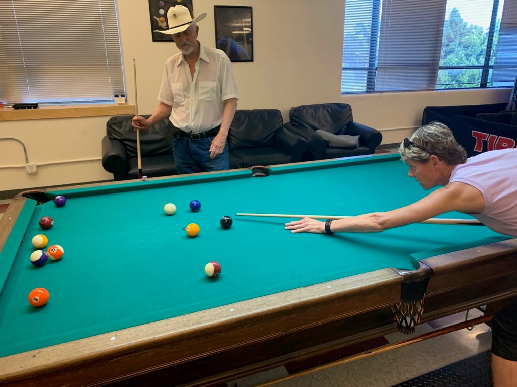Lisa Peake, right, playing pool with a veteran resident.