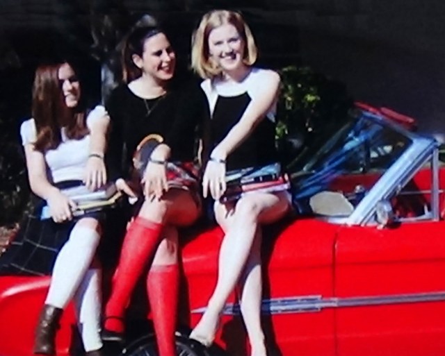 1970, girls sitting on a red car wearing POW/MIA bracelets.