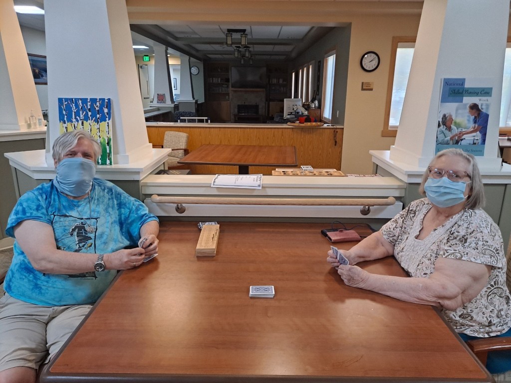 Residents at the Redding Home play cards as they visit for Mother's Day.