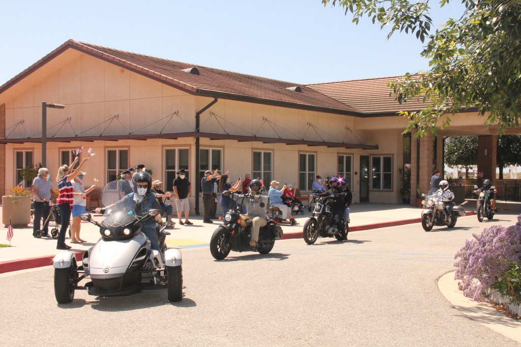 Residents of Ventura Veterans Home watch motorcyles ride by.