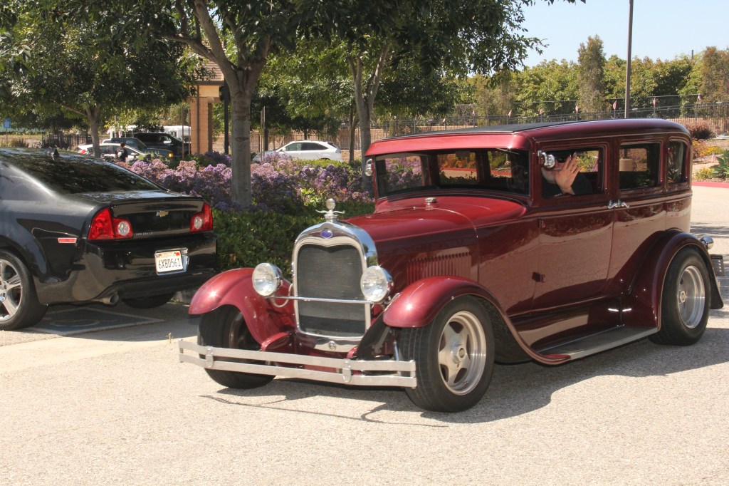 Red classic car joined the parade.