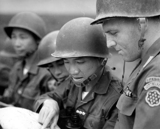 U.S. military and south Vietnamese consulting a map.