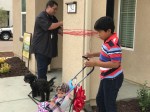 Son Kiero and daughter Zaniah Joy wait for the ribbon to be tied in place.