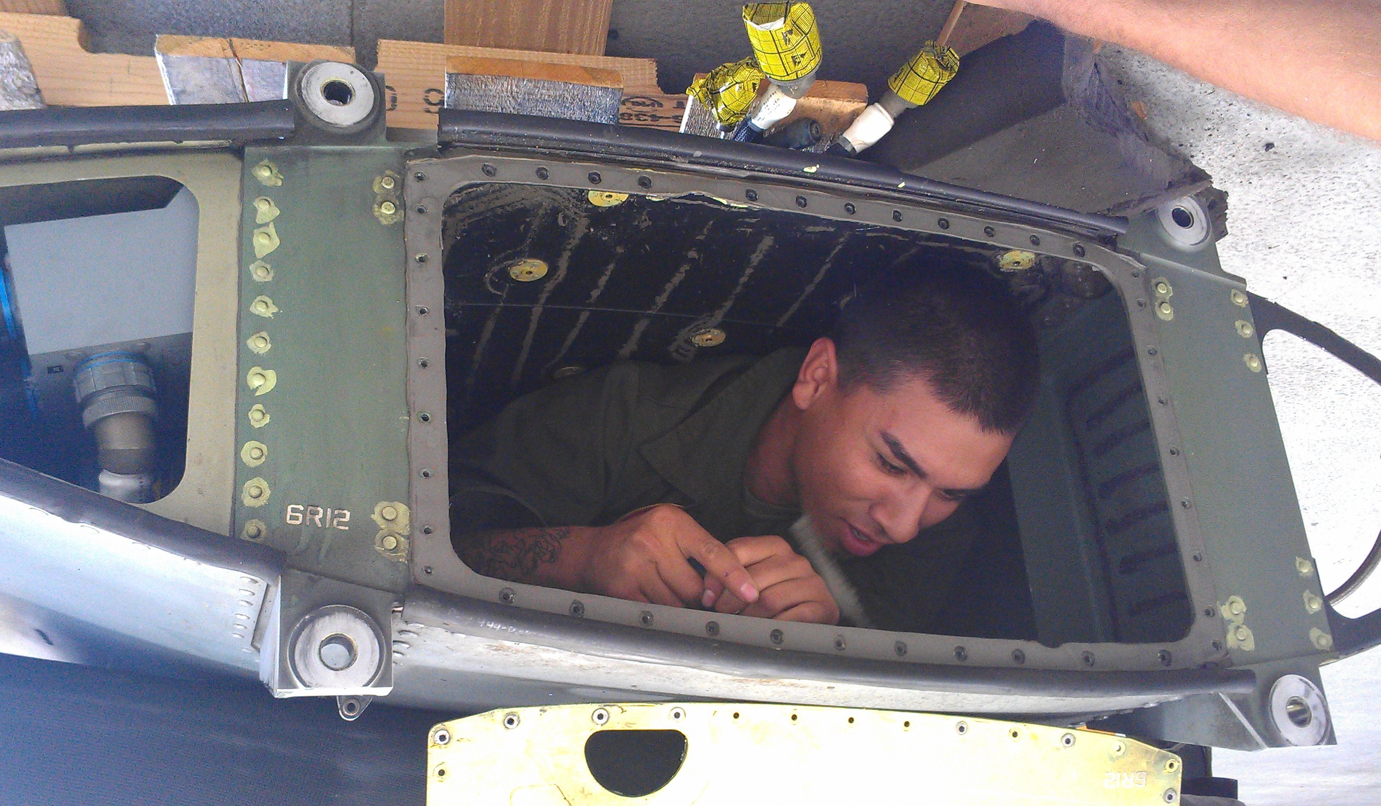 Jesus working maintenance on helicopter.