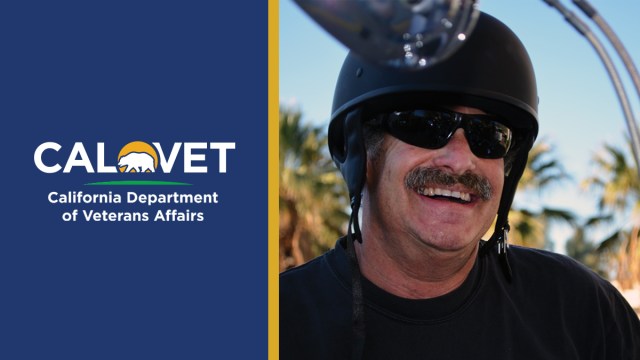 A smiling veteran sits on his new Harley.