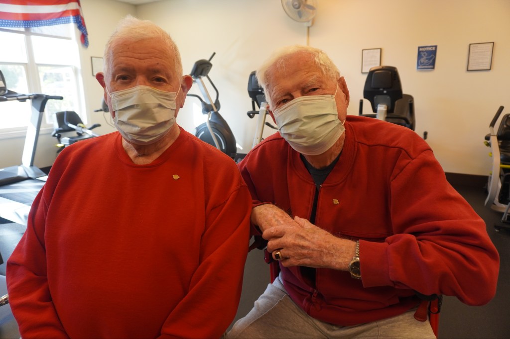 Resident veterans at the Ventura Veterans Home wearing their gold pins on red shirts.