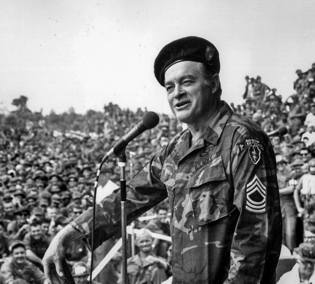 Bob Hope talking on the mic to the troops during Vietnam.