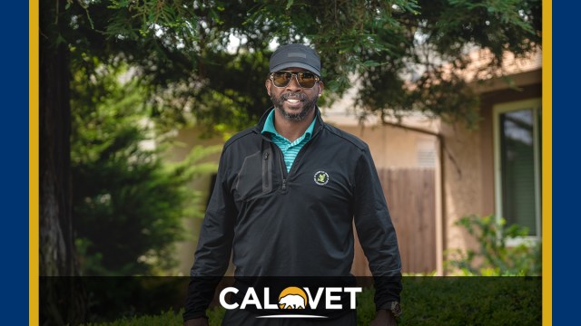 Waist high shot of veteran in front of his new home.