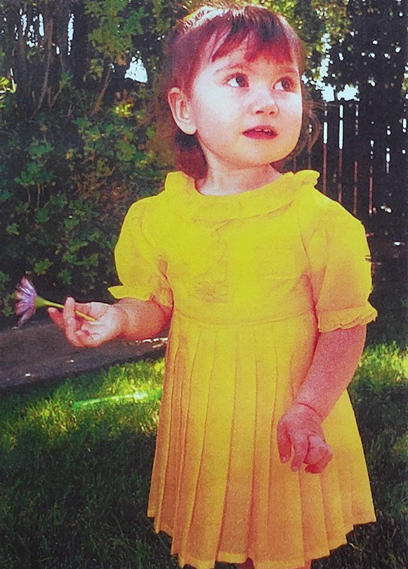 Jaycee, grand grandniece of G.W. Trotter wearing the yellow parachute dress.