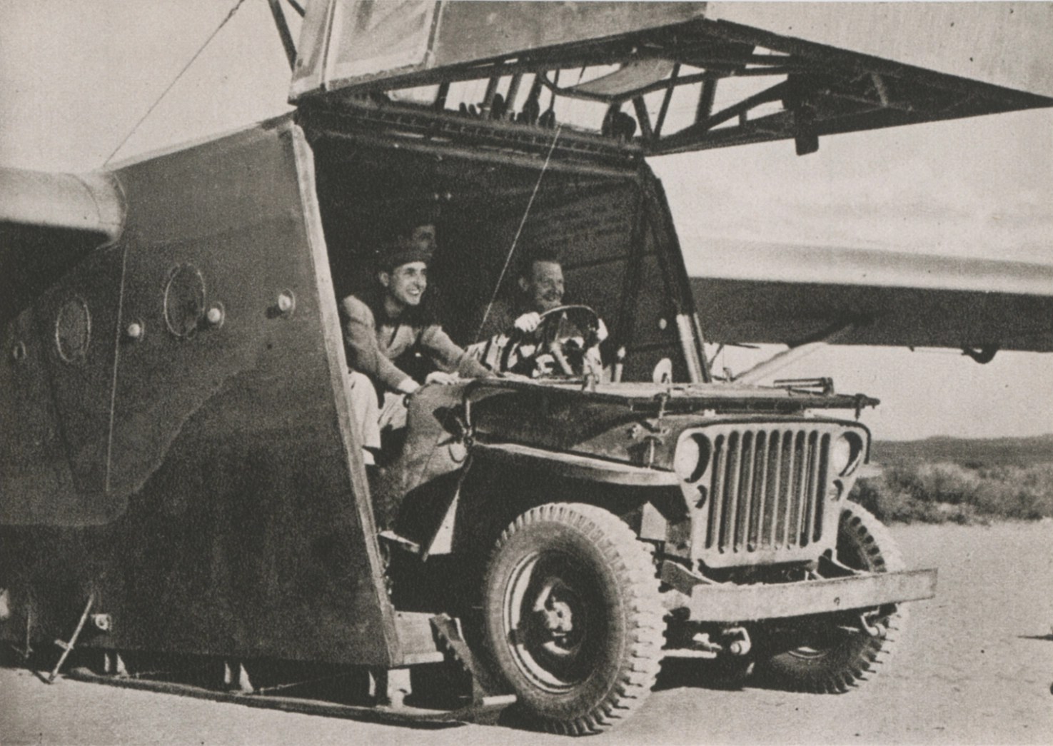 A Jeep is being offloaded from a glider.