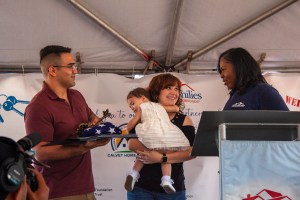 A family on stage receiving ceremonial key at event.
