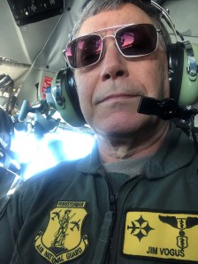 Man in helicopter with headset.