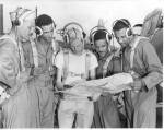 Group of men looking at map.