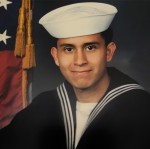 Navy servicemember in uniform.