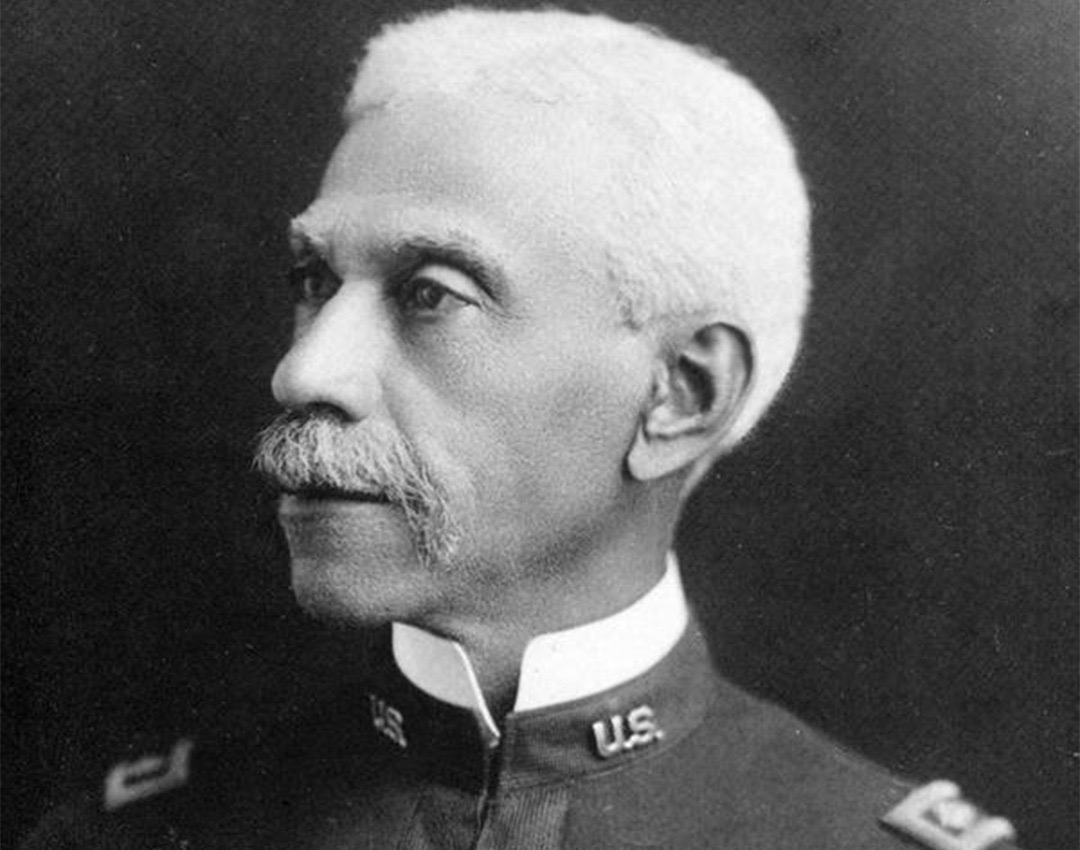 Black and white image of soldier in military uniform.